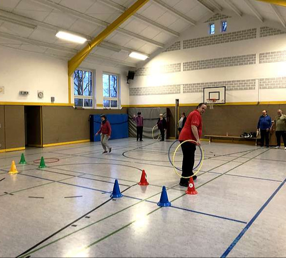 Die Herzsportgruppe Hahnentange beim Spiel mit Gymnastikringen.